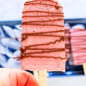 a chocolate drizzled creamy cherry popsicle