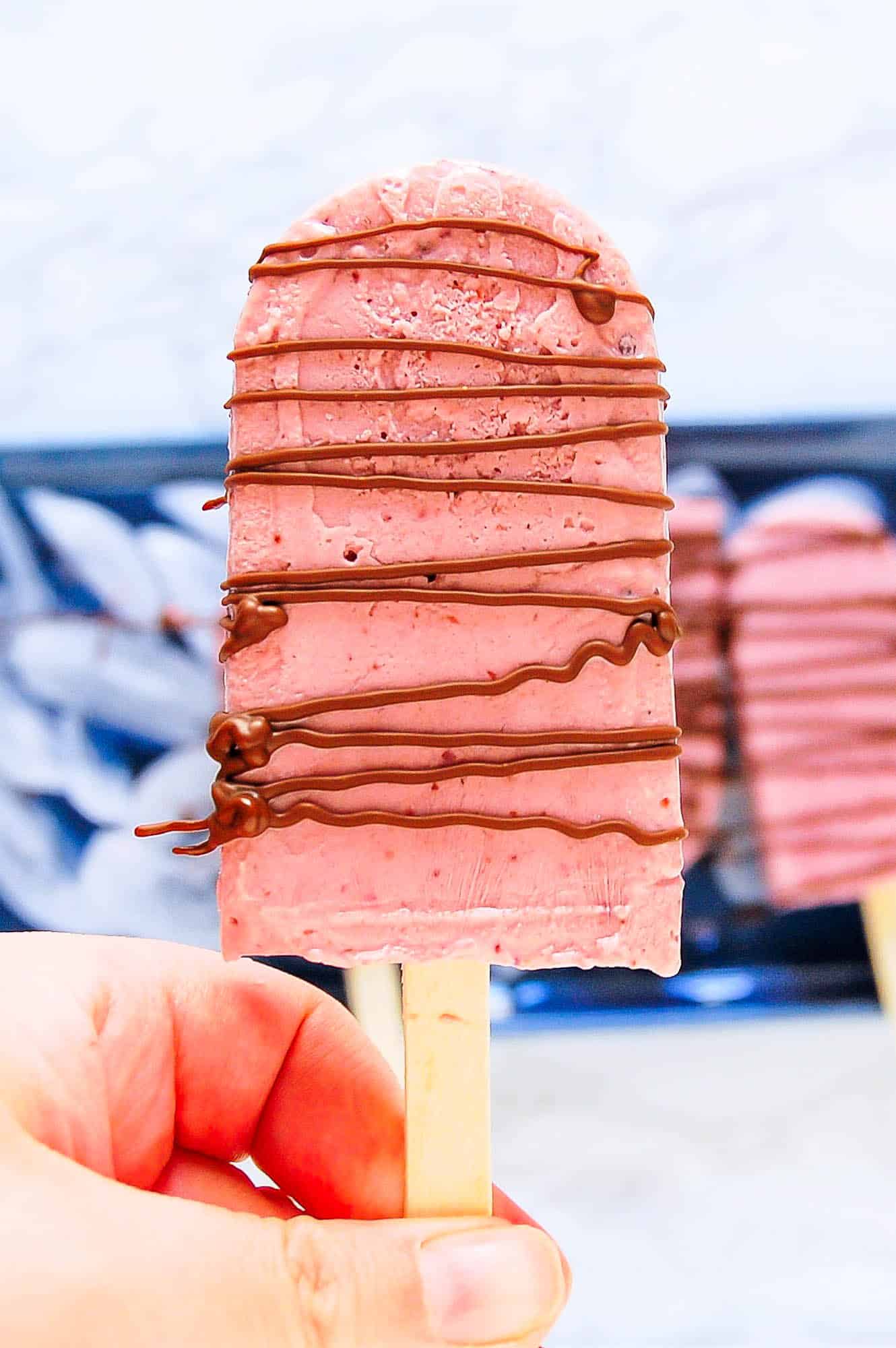 a chocolate drizzled creamy cherry popsicle