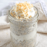 a har of coconut cream pie overnight oats layered with whipped cream