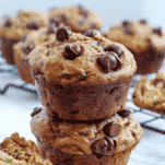 two banana zucchini chocolate chip muffins stacker on each other