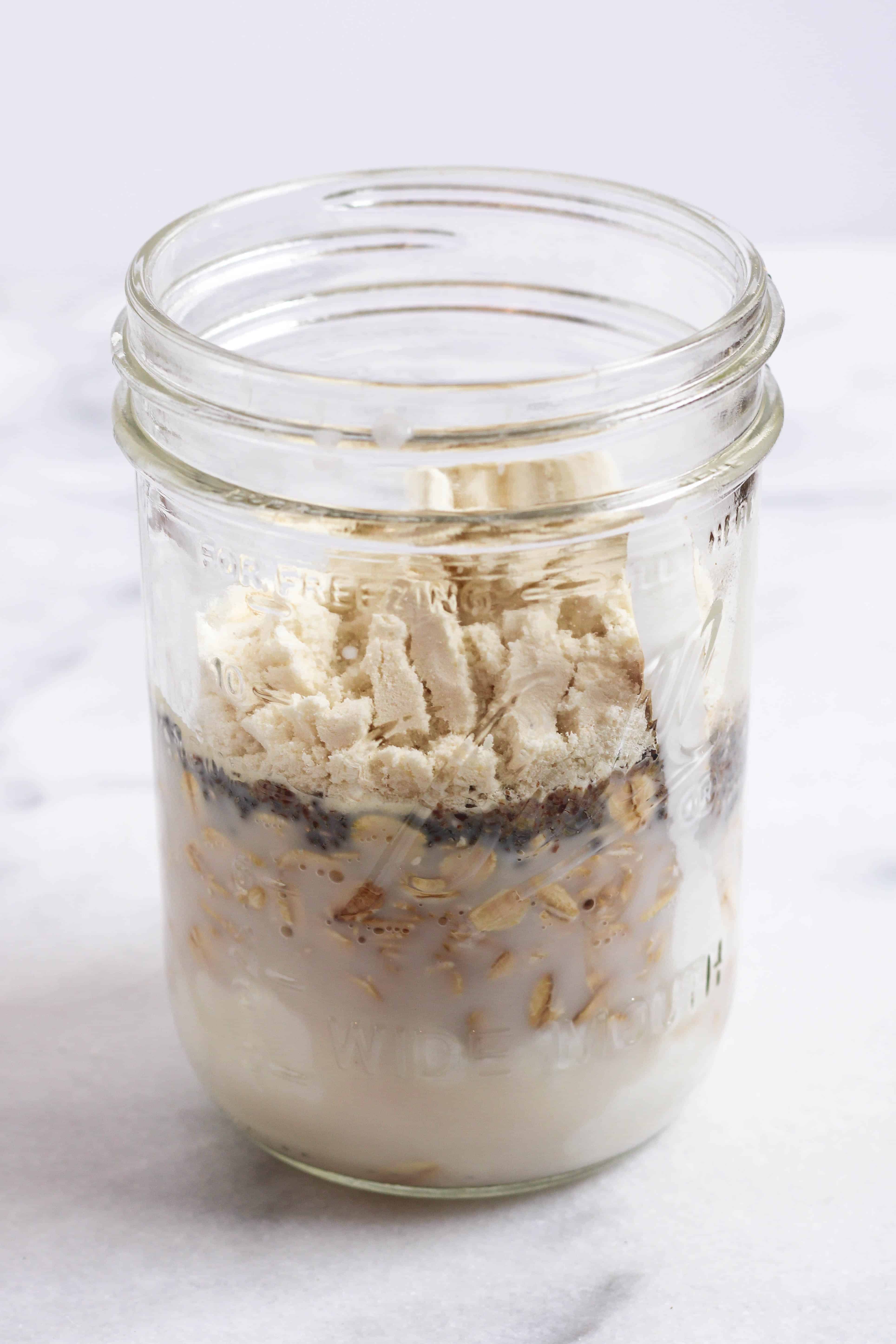 a jar of ingredients waiting to be mixed up to make cookie dough protein overnight oats