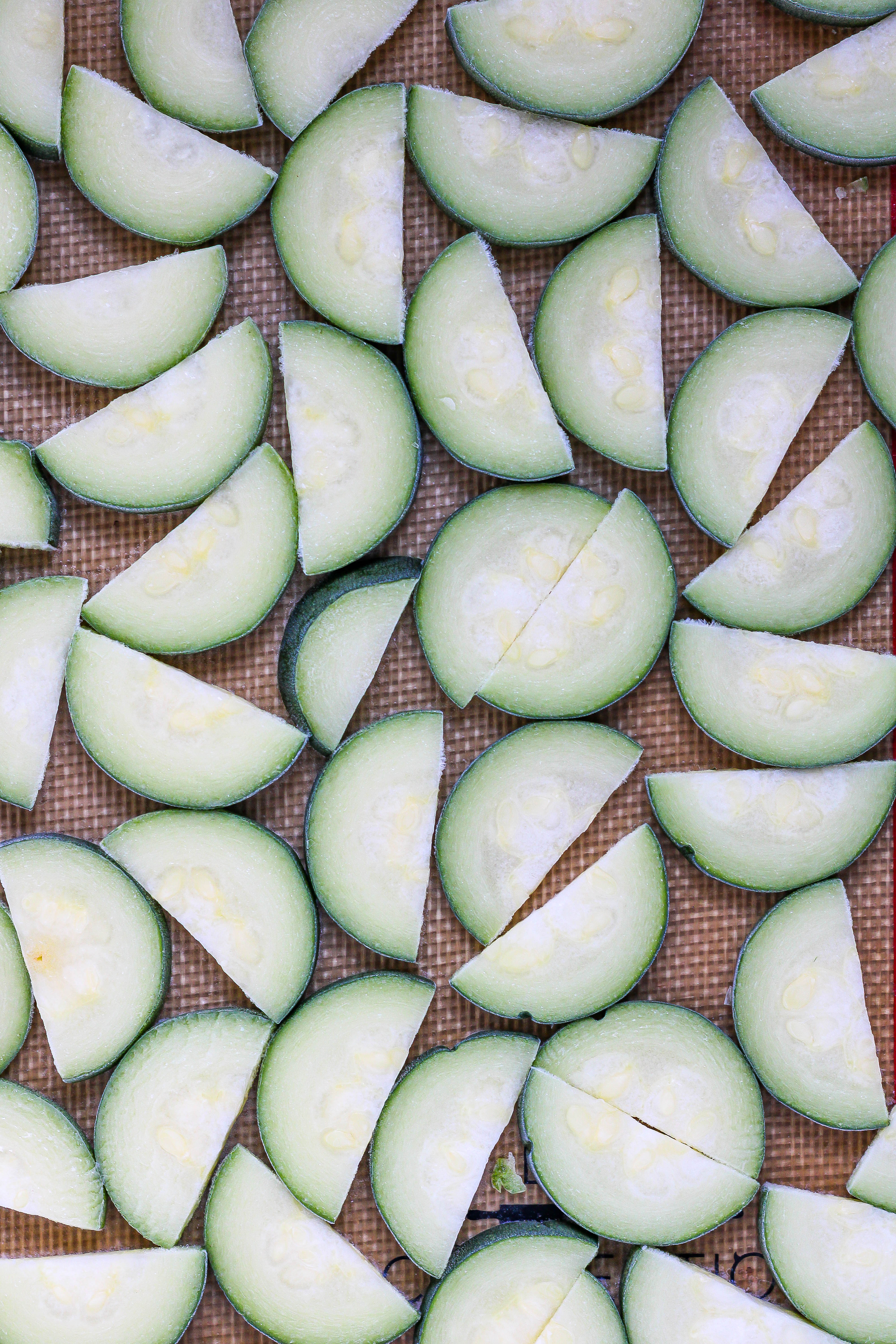 frozen zucchini slices on a sheet pan