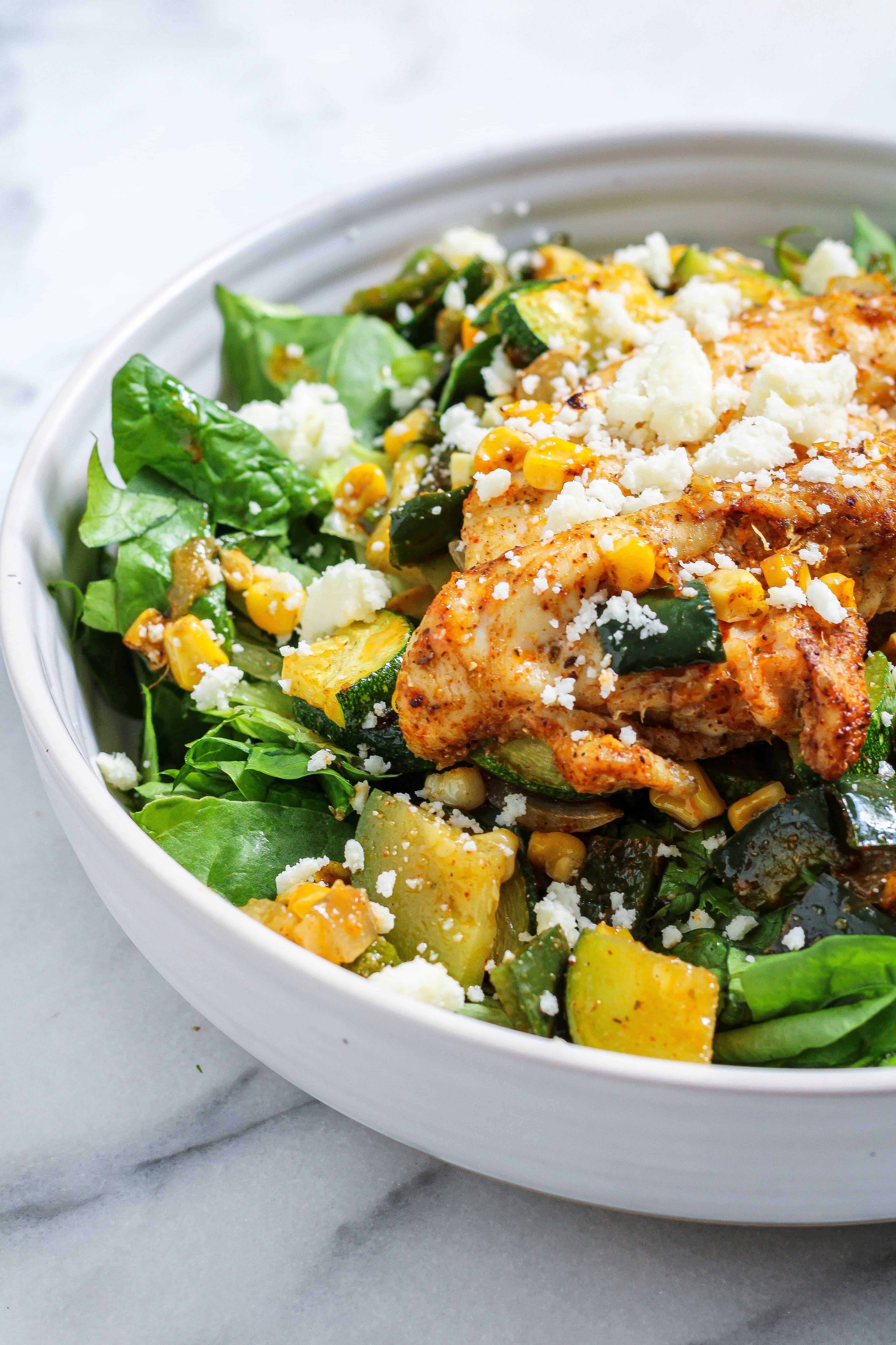 poblano corn salad with chicken in a bowl topped with queso fresco