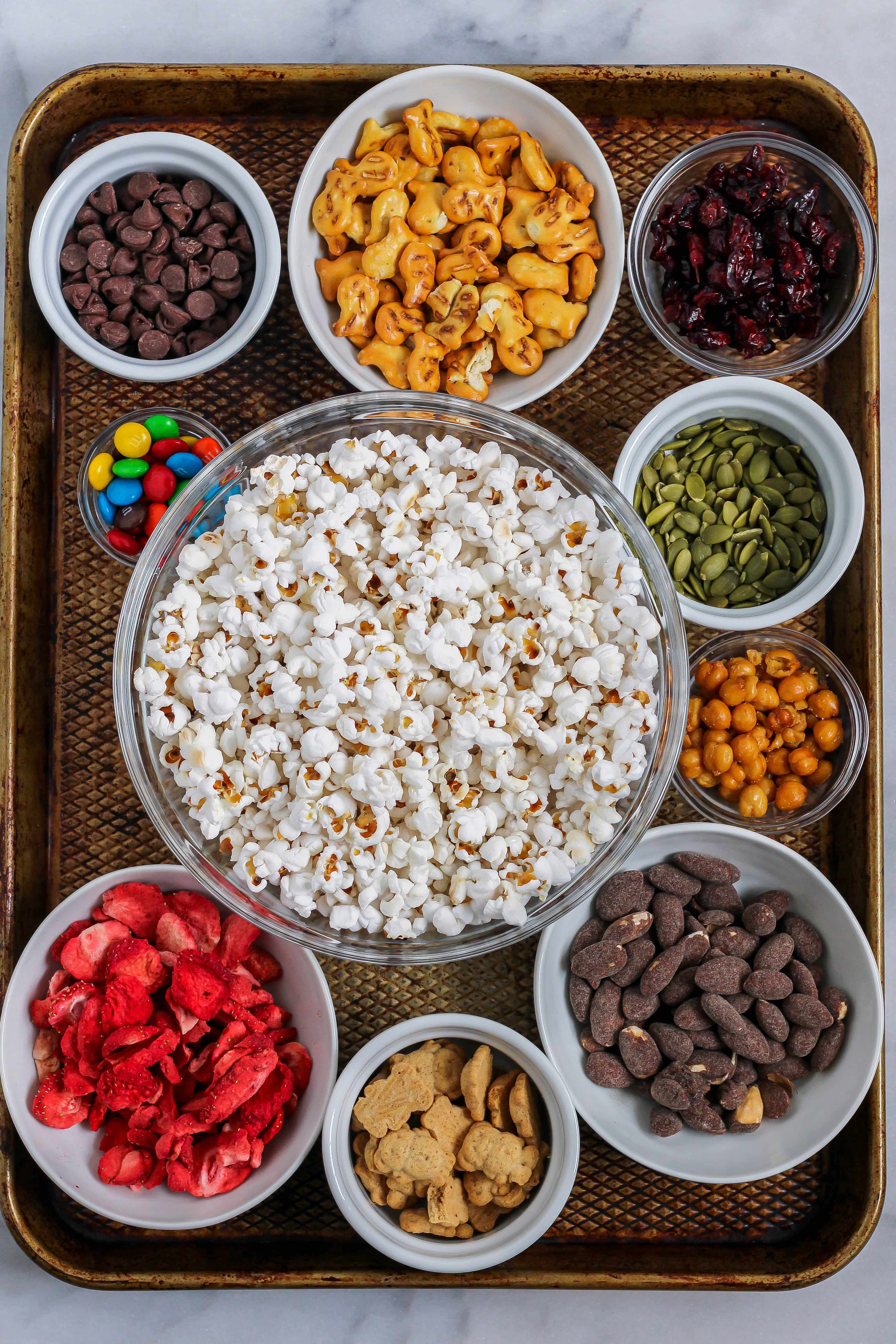 assorted ingredients to make popcorn trail mix