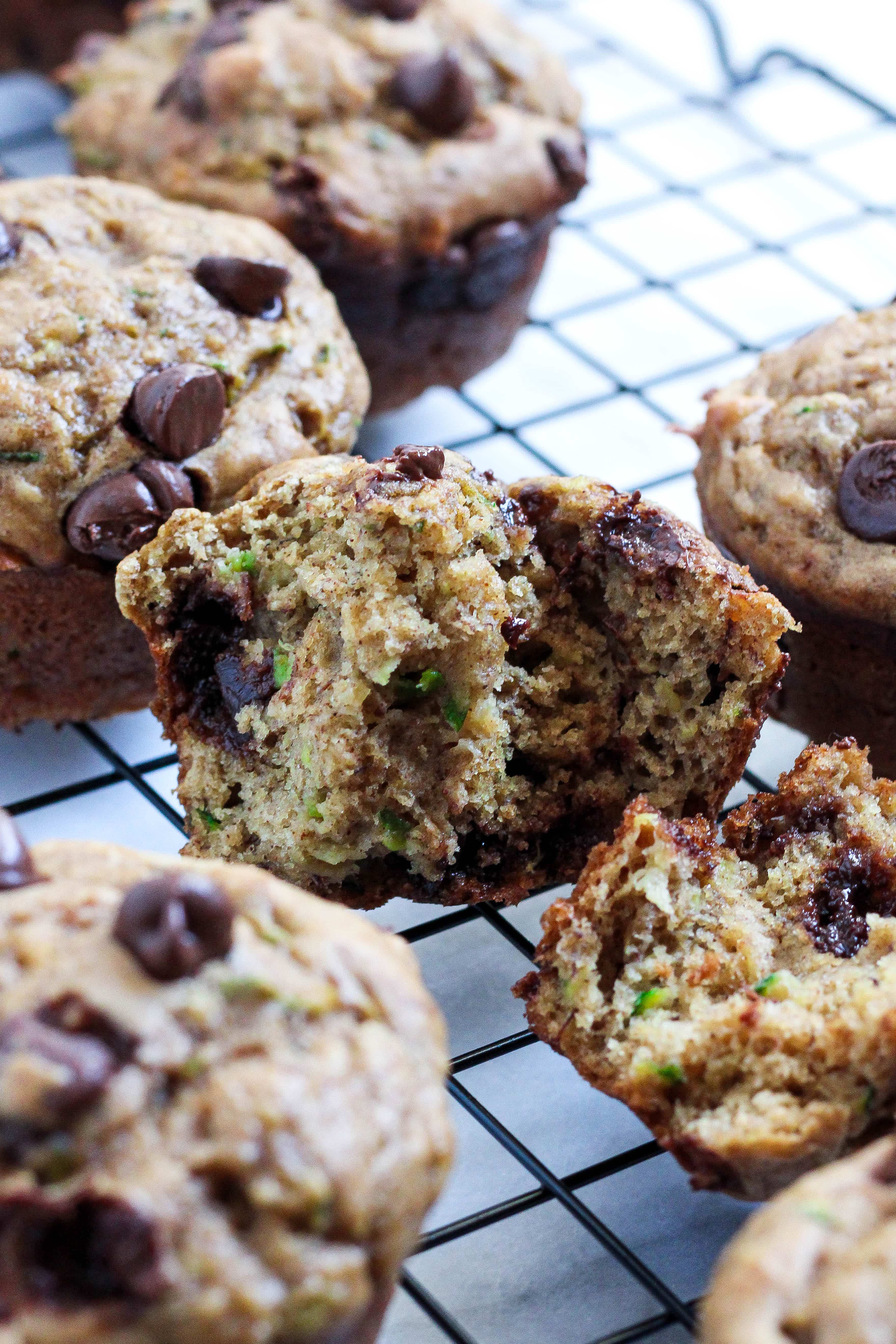 half of a muffin showing the tender crumb of the zucchini banana chocolate chip muffin