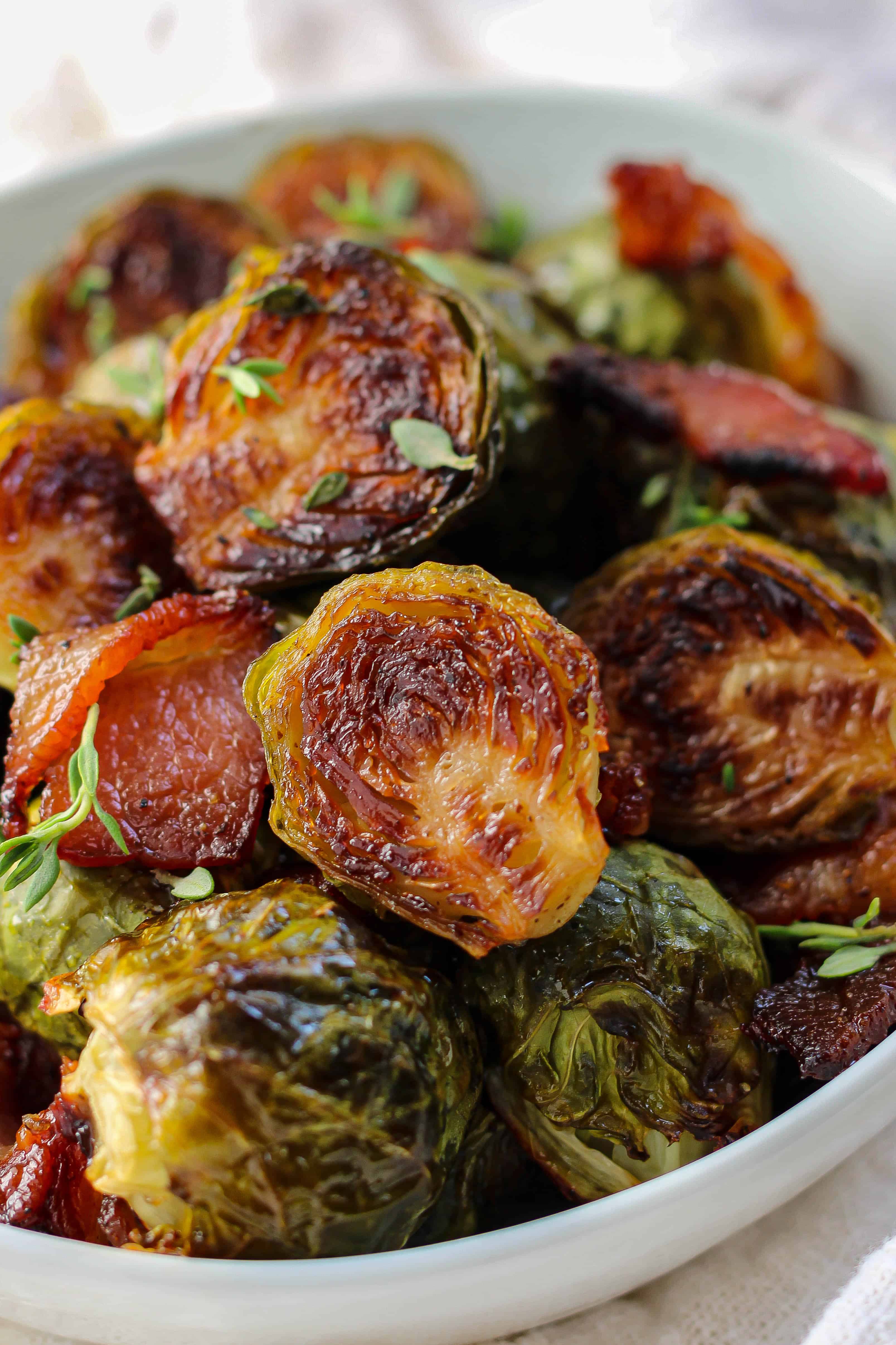 a bowl of crispy maple balsamic brussels sprouts with bacon