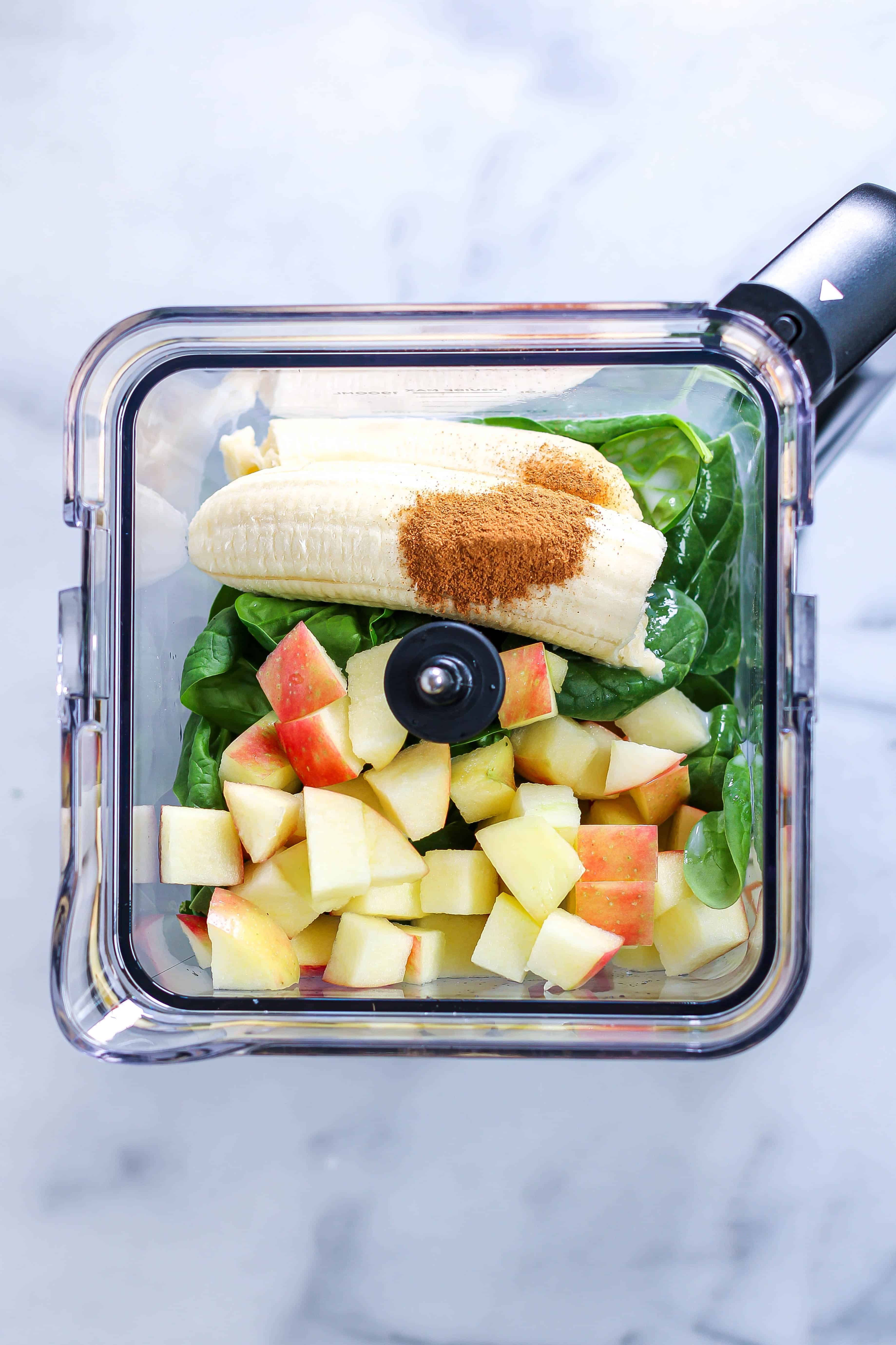 spinach banana apple smoothie ingredients in a blender, pre-blending