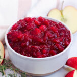 a ceramic bowl of apple cider cranberry sauce