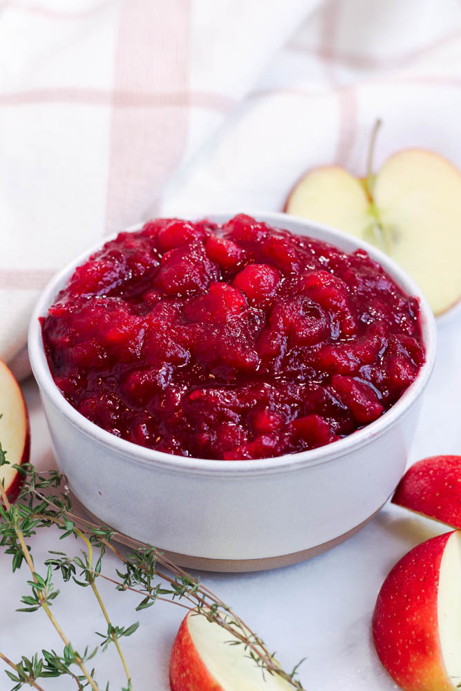 a ceramic bowl of apple cider cranberry sauce