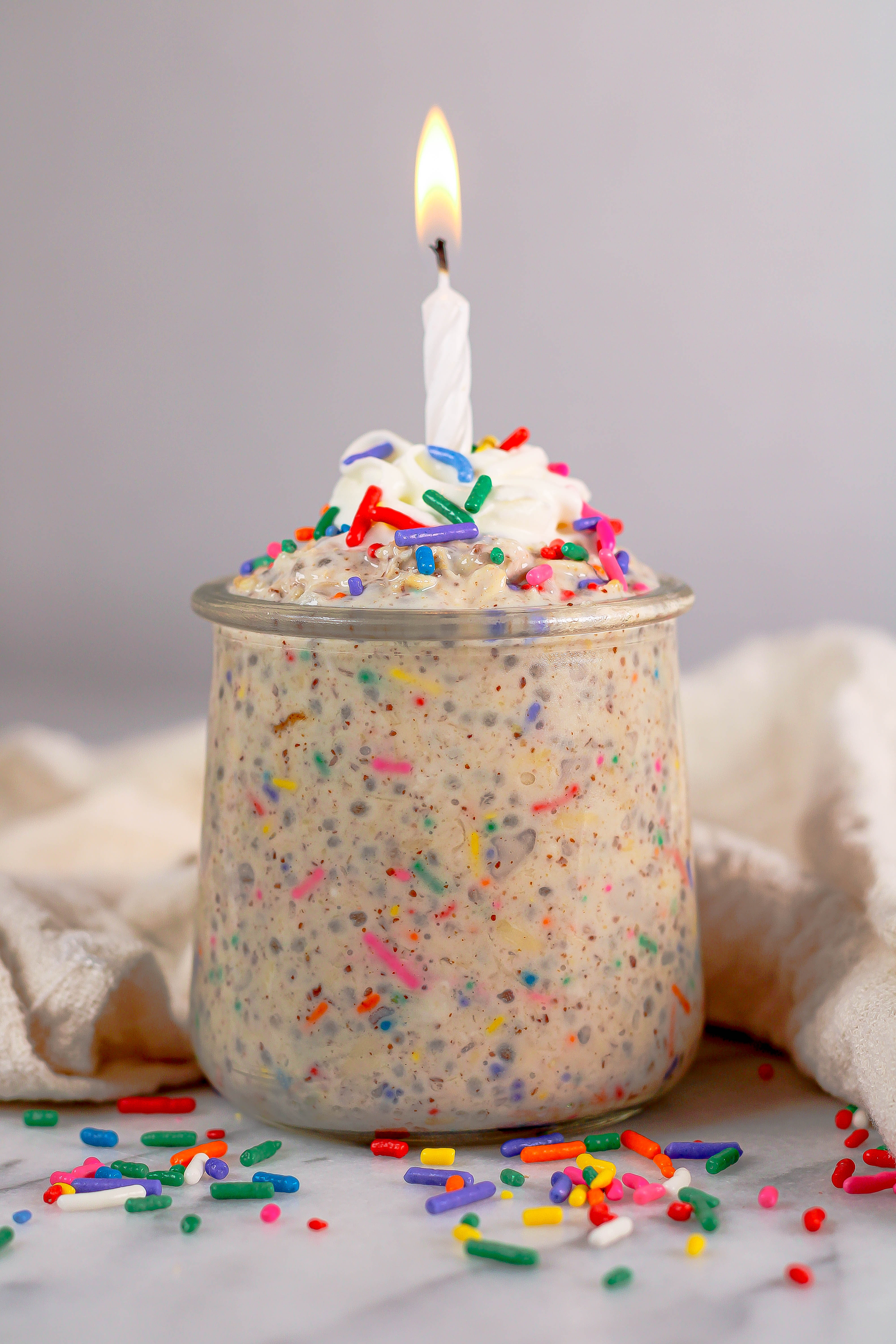 birthday cake batter overnight oats with a birthday candle