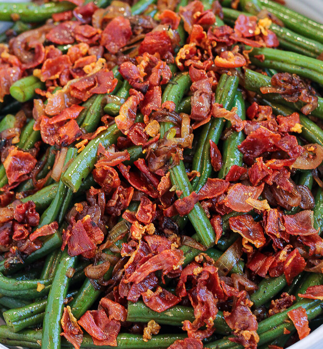 a bowl of tender green beans, caramelized shallots, and crispy prosciutto for prosciutto green beans