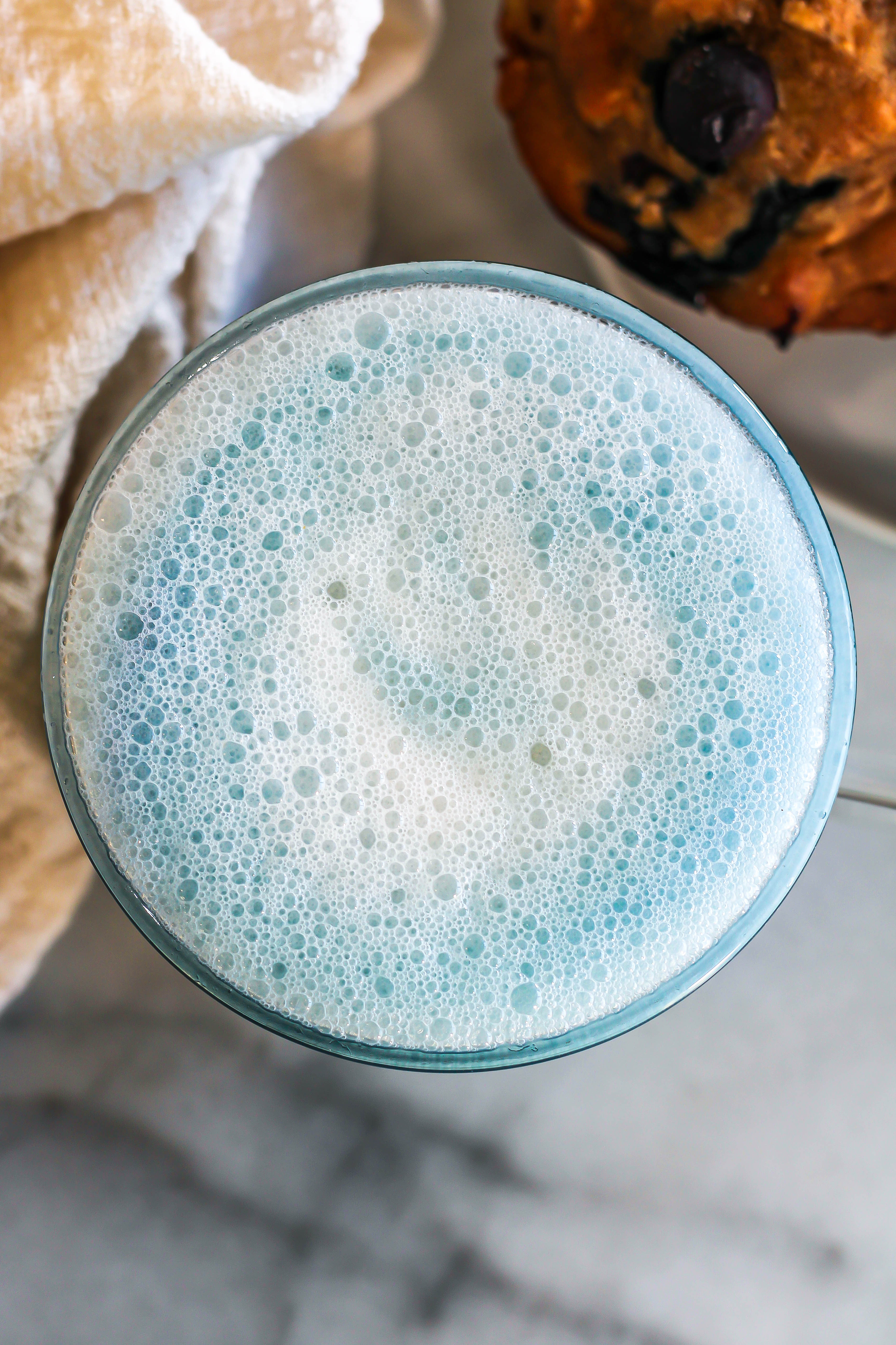 a frothy blue latte
