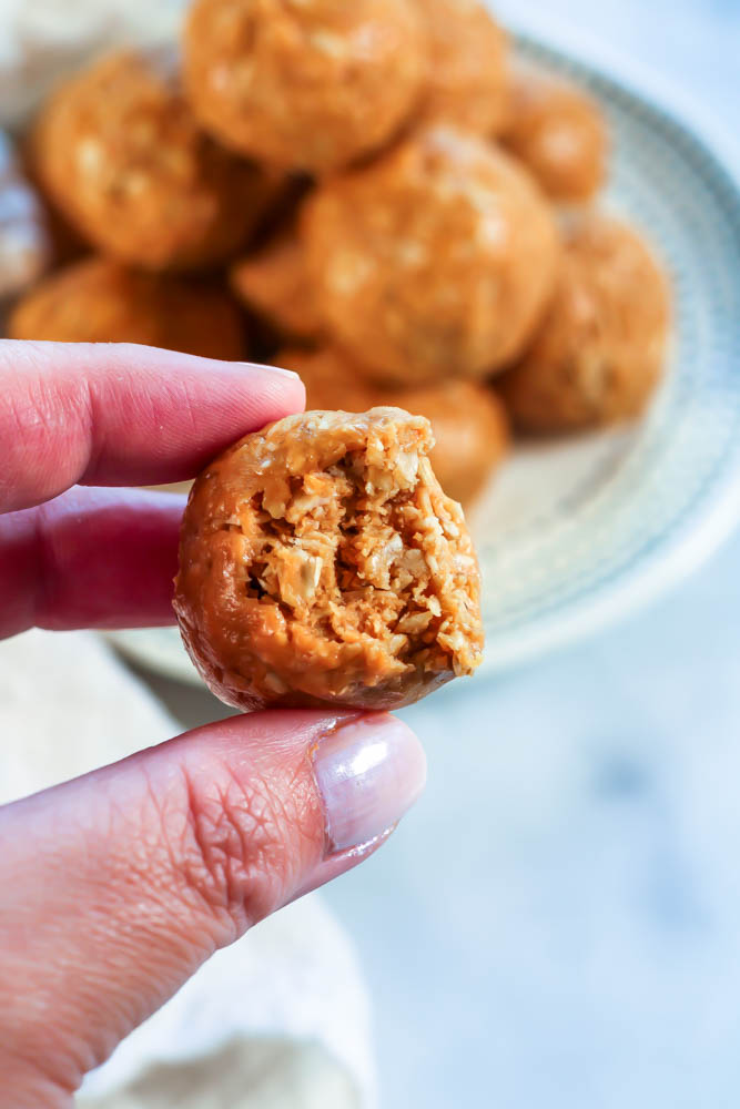 a bite taken out of a 3 ingredient peanut butter oatmeal ball
