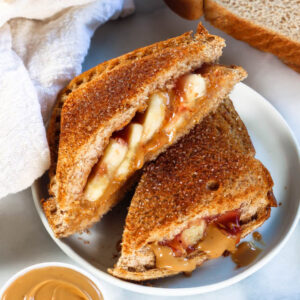 a banana peanut butter jelly sandwich air fried with a crisp cinnamon sugar coating