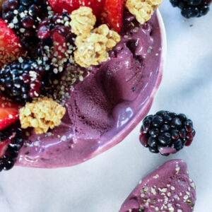 a spoonful of acai ice cream as the base of a high protein acai bowl