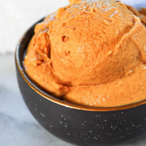 a black bowl of ninja creami pumpkin ice cream high protein pumpkin ice cream