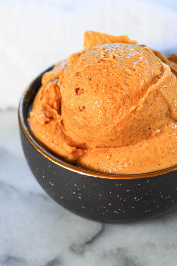 a black bowl of ninja creami pumpkin ice cream high protein pumpkin ice cream