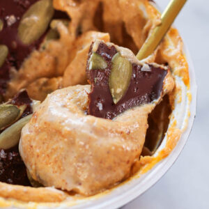 pumpkin spice yogurt with chocolate shell topping and pepitas