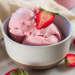 strawberry cottage cheese ice cream in a tan bowl