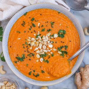 a bowl full of creamy cashew carrot ginger soup