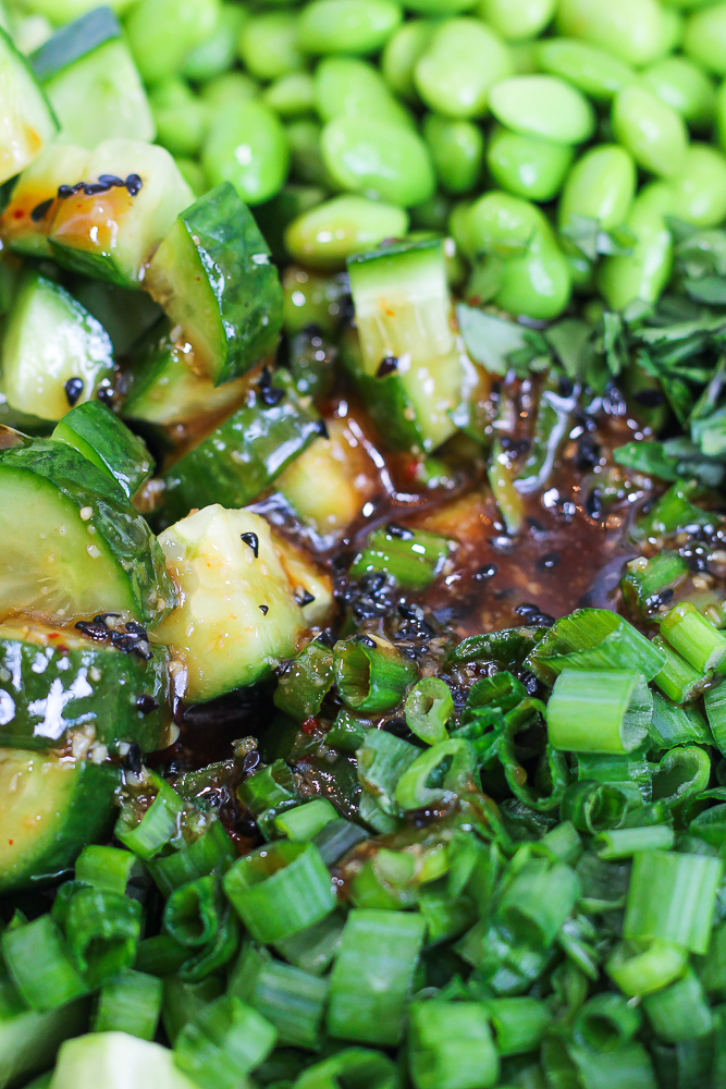 close up of sweet chili sesame dressing poured over edamame cucumber salad