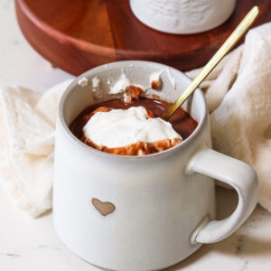 protein powder in hot chocolate in a mug with whipped cream