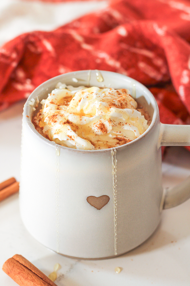 a cozy mug with a heart on it filled with cinnamon honey latte