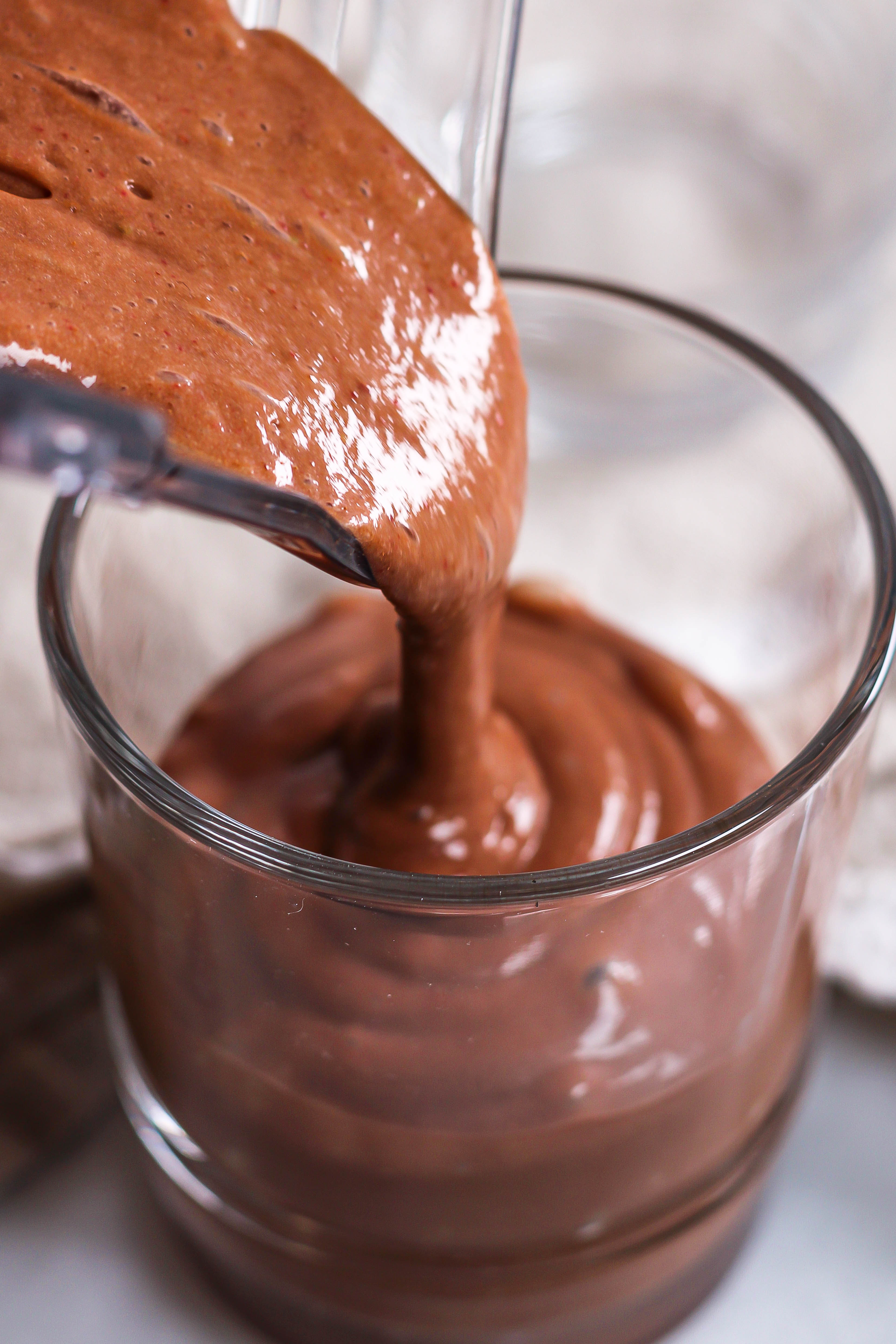 pouring a chocolate strawberry banana smoothie