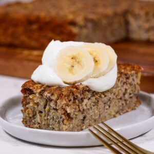 a slice of banana bread baked oatmeal topped with greek yogurt and banana slices