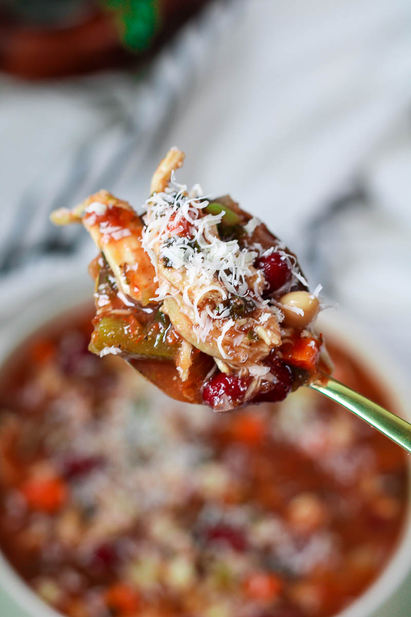 a spoonful of chicken minestrone soup with parmesan