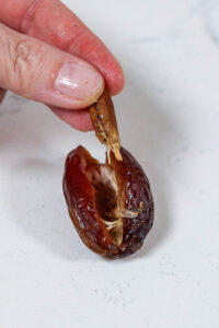 removing pit from medjool date for chocolate dates