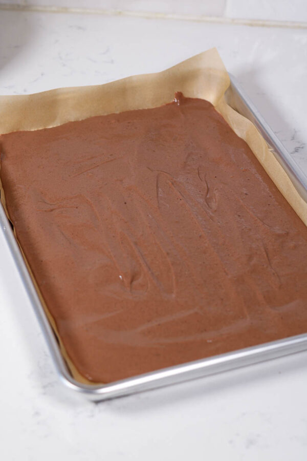 spread chocolate protein yogurt mixture out on a pan to make yogurt bark