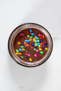 candy coated chocolate sprinkles on cosmic brownie overnight oats