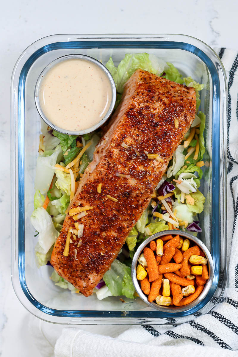 tajin air fryer salmon served over a salad