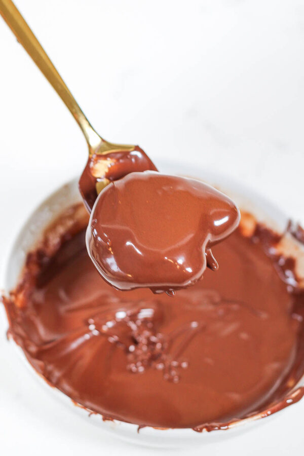 dipping a medjool date in chocolate for chocolate dates