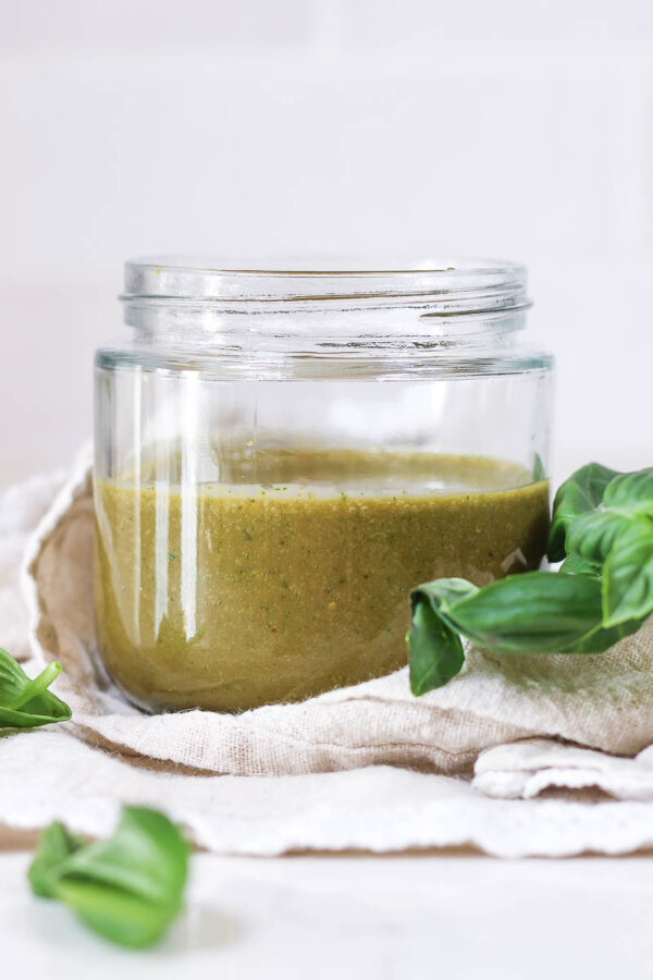 basil balsamic dressing in a glass jar on a linen napkin