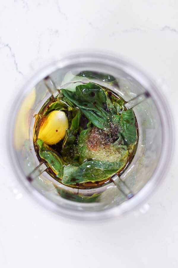 Ingredients in a blender to make basil balsamic vinaigrette