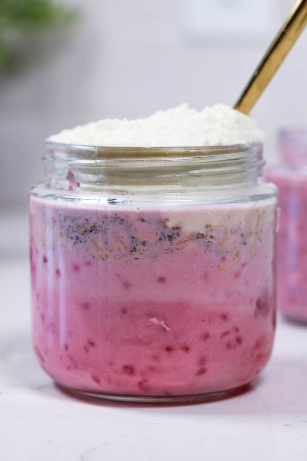 ingredients in a glass jar to mix for raspberry overnight oats