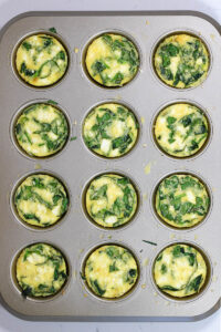 spinach feta egg bites freshly cooked in the muffin pan