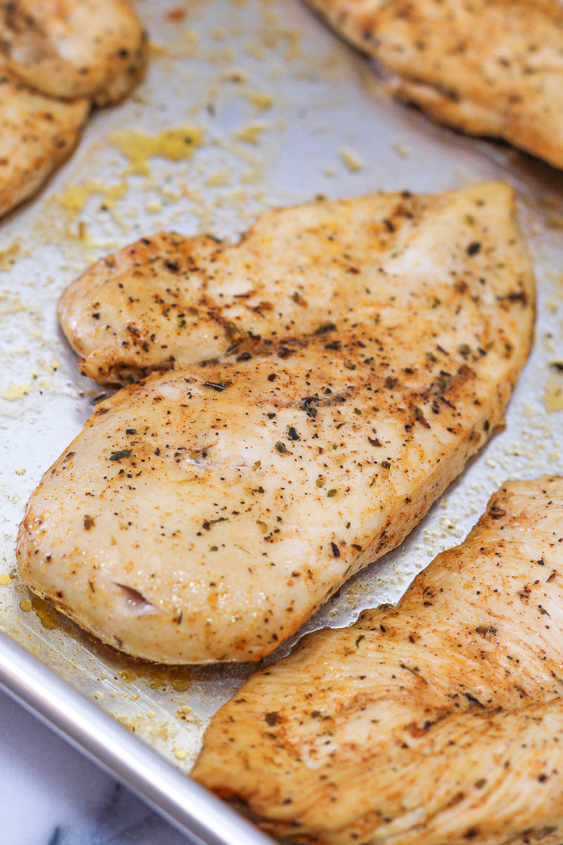 sheet pan of baked thin sliced chicken breast