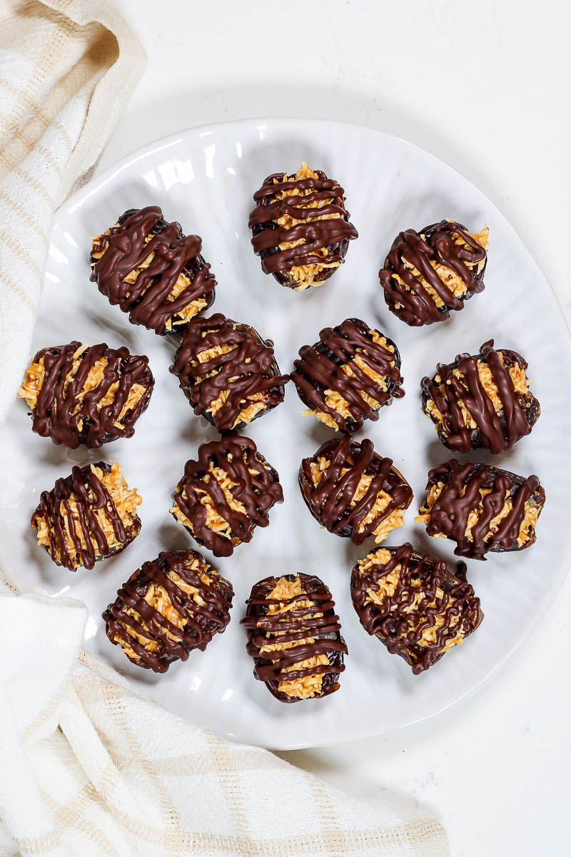 a plate of coconut dates drizzled with dark chocolate