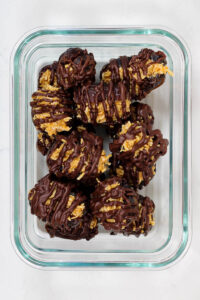 a container of chocolate drizzled coconut dates from a weekly meal prep