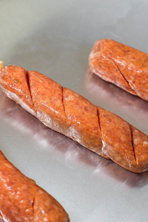 slicing the sausages for sheet pan honey mustard sausages