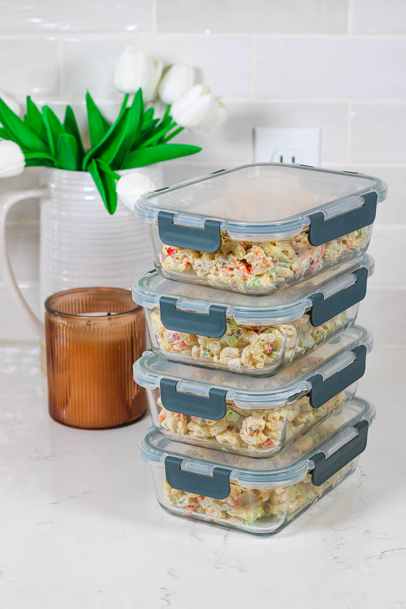 stacked meal prep containers of healthy chicken macaroni pasta salad