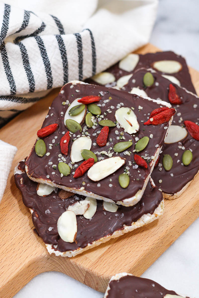 a wooden board topped with chocolate covered rice cakes