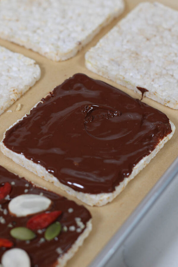 topping rice cakes with chocolate