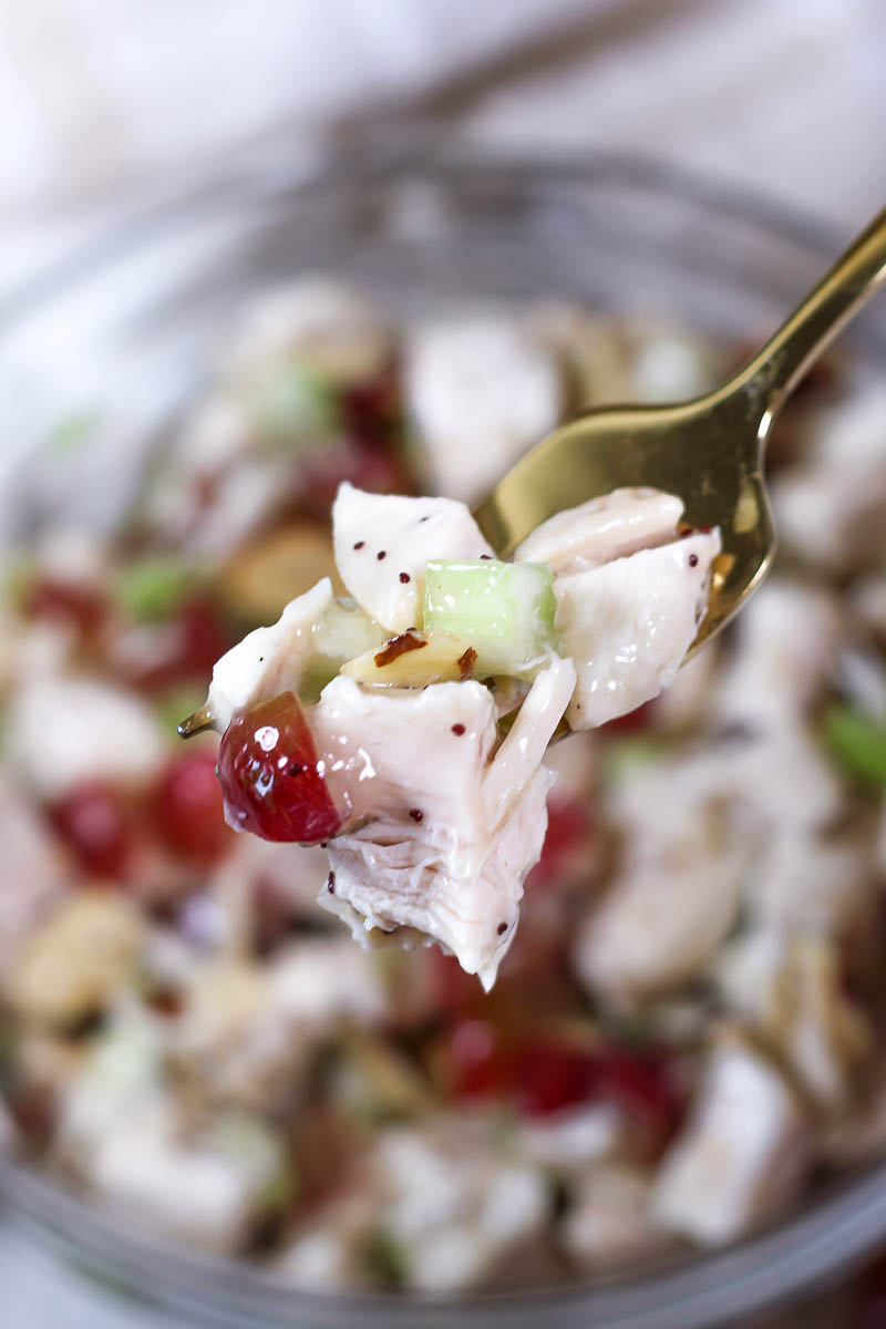 a bite of poppy seed chicken salad on a golden fork