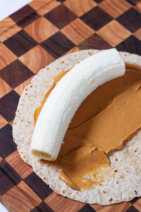 peanut butter and a banana on a tortilla to make banana sushi