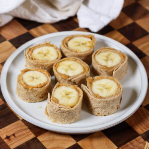 a plate of banana sushi