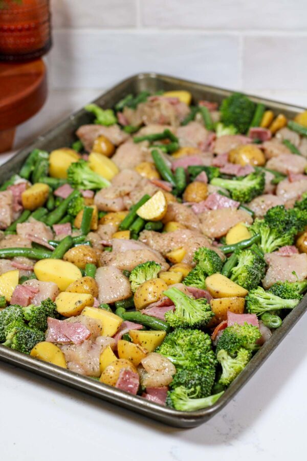 ingredients to make a chicken bacon ranch bowl all on a sheet pan